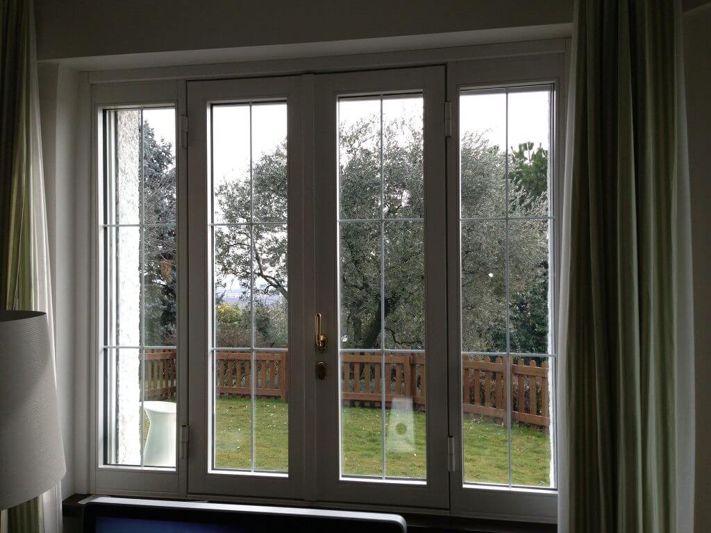  A photo of a custom security window overlooking a fenced-in backyard.