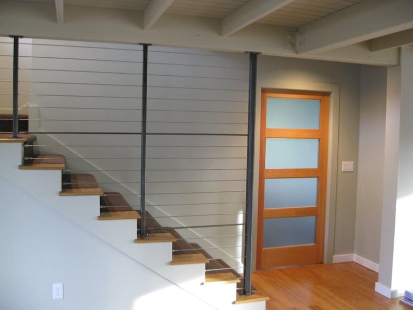 A photo of a custom security door at the bottom of the basement stairs. 