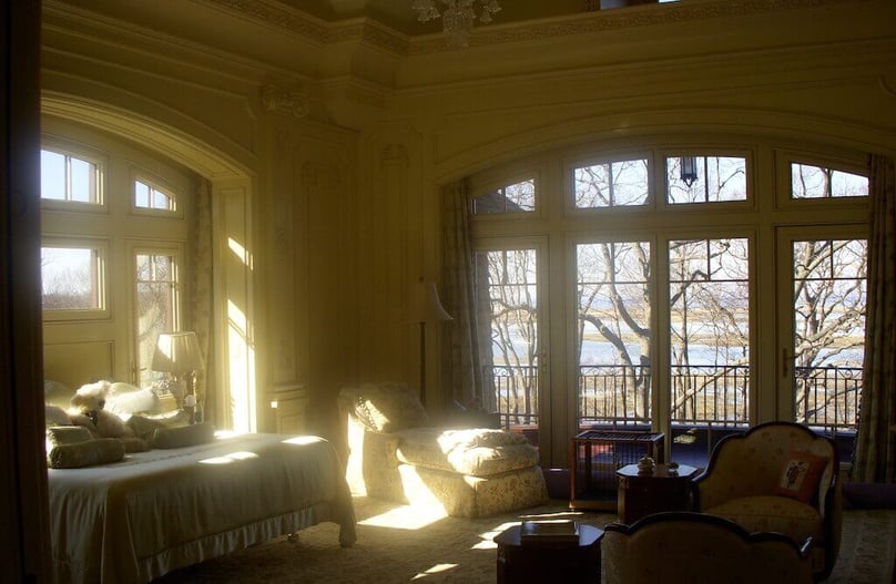A photo of the interior of a bedroom featuring large, elegant security windows.