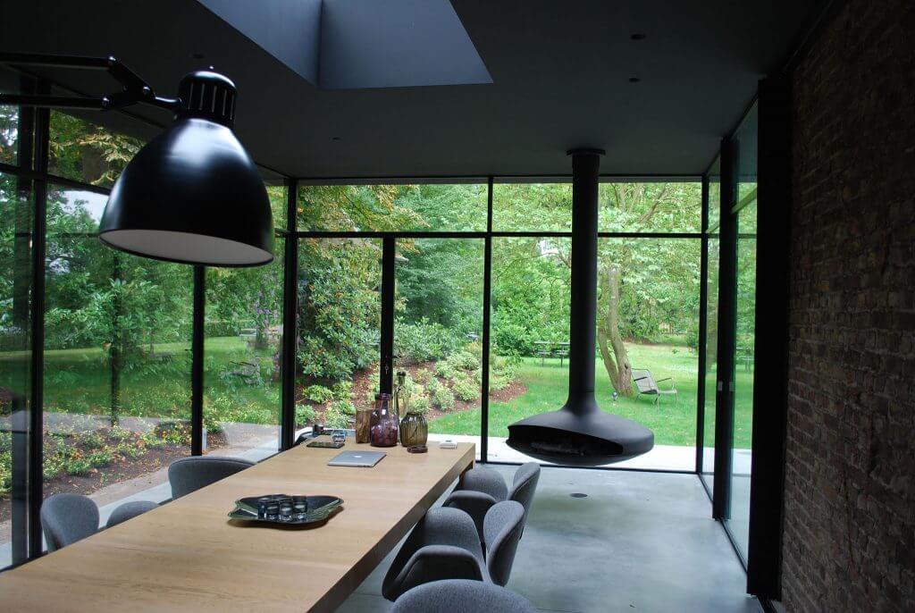 A photo of a large dining room featuring floor-to-ceiling custom security windows on two sides.
