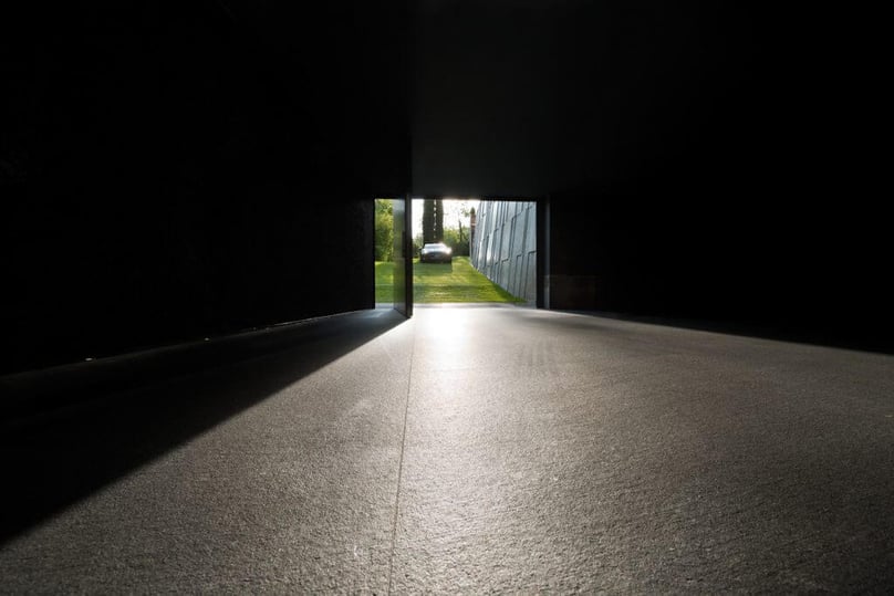 A photo of a massive pivot door serving as a garage door.