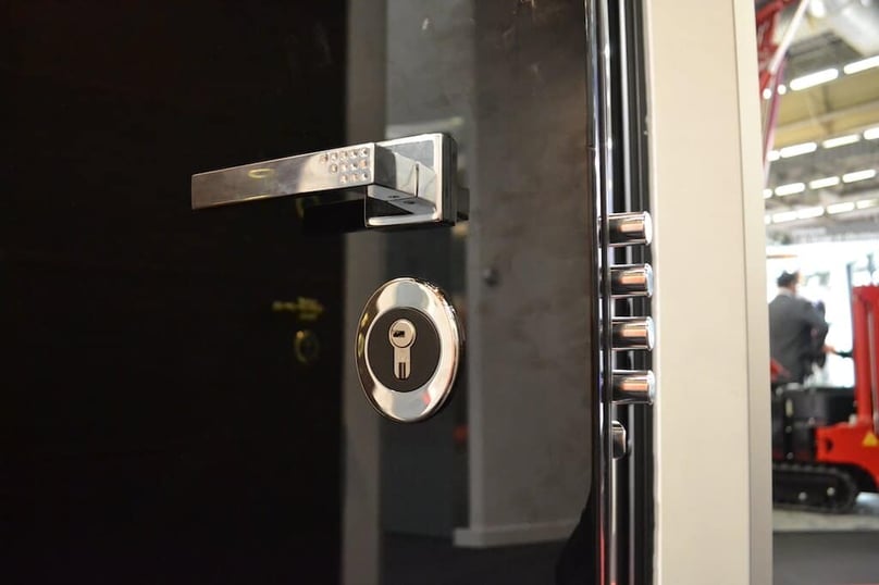 A close-up photo of a polished silver luxury door handle accented by tiny gemstones.