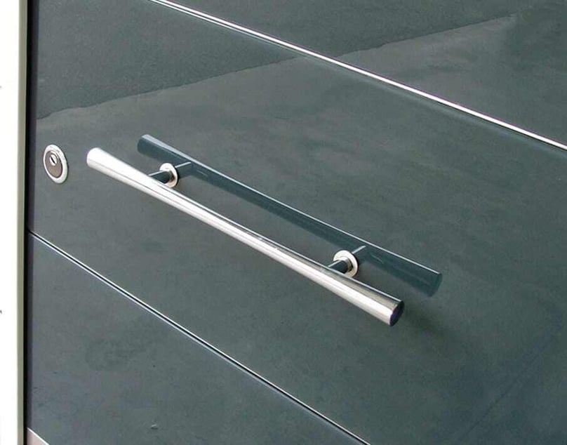 A close-up photo of a contemporary luxury door handle on a custom security door.