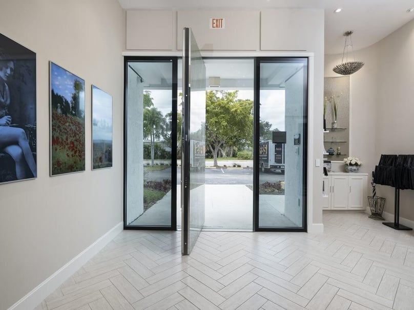 A photo of a large pivot door at the entrance to FBS headquarters.