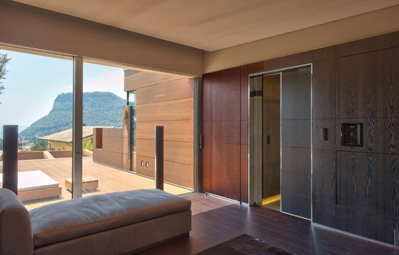 A photo of a large hurricane window in sitting room of a luxury home.