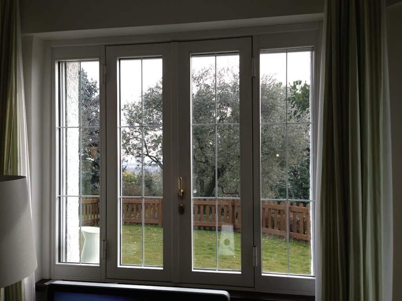 A photo of a residential security window overlooking a fenced in backyard.