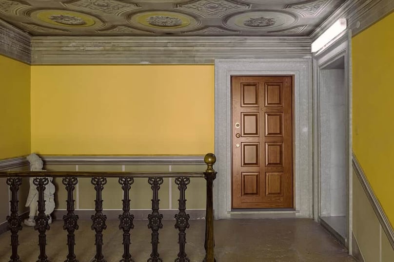A photo of a wooden security door at the entrance of a master bedroom.