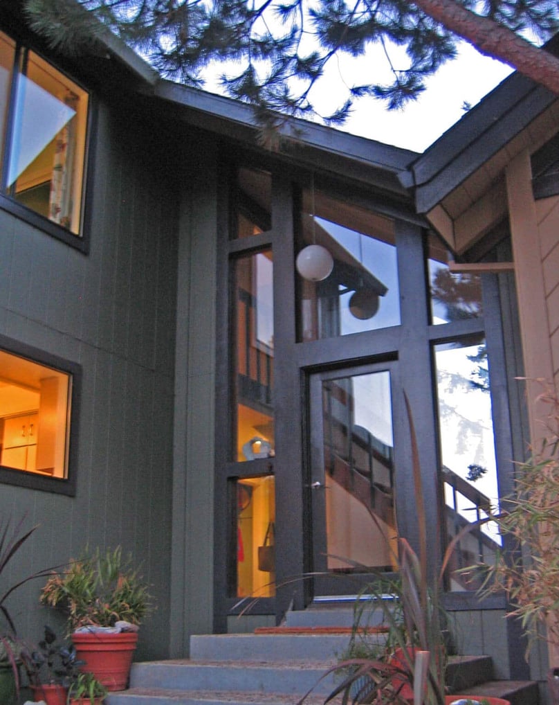 A photo of the exterior of a house with security doors and windows