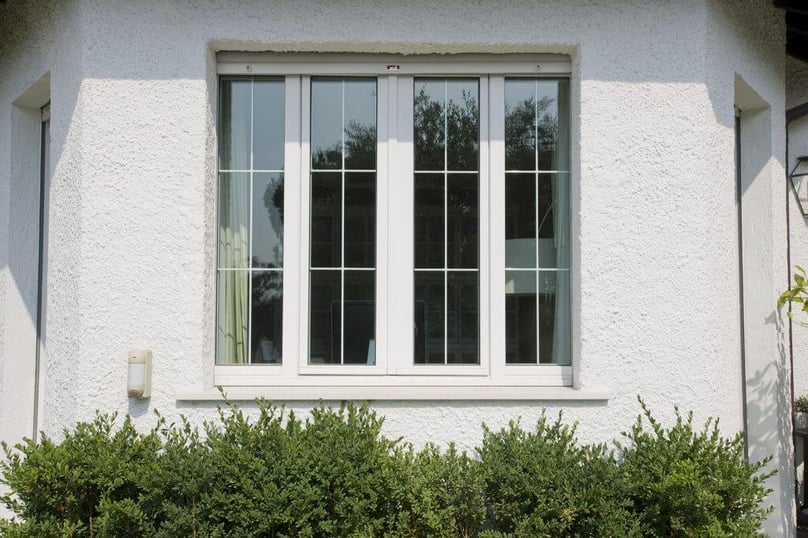 A photo of a hurricane window from the exterior of a house.